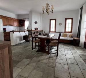 a kitchen and living room with a table and chairs at Sea & Mountain Pelion in Mouresi