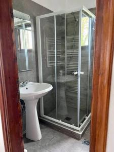 a bathroom with a glass shower and a sink at Sea & Mountain Pelion in Mouresi