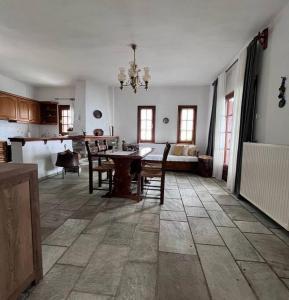 a kitchen and dining room with a table and chairs at Sea & Mountain Pelion in Mouresi