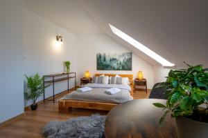 a bedroom with a bed and some plants in it at Centrum Bieszczad in Lutowiska