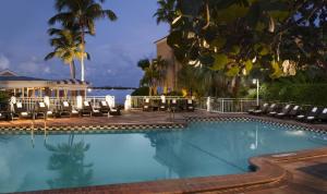 a large swimming pool with chairs and a building at Pier House Resort & Spa in Key West