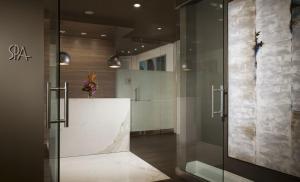 a lobby with a glass door and a counter at Pier House Resort & Spa in Key West