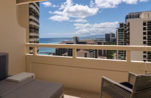 a balcony with a view of the ocean at Sheraton Waikiki Beach Resort in Honolulu