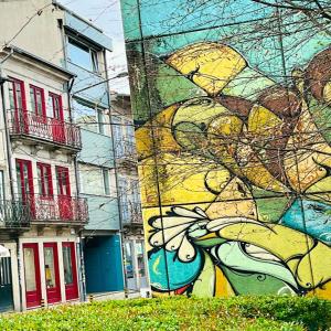 a building with a mural on the side of it at bnapartments Trindade in Porto