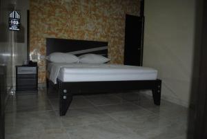 a bed with two pillows on it in a room at Hotel Mi Palermo in Bucaramanga