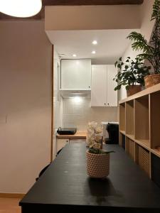 a kitchen with a black table in a room at HGC Barcelona in Barcelona