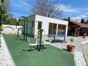 a playground with a table and a bench and a table at Bajor Panzió Bük-Bükfürdő, Adults Only 12plus in Bük