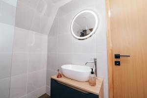 y baño con lavabo blanco y espejo. en Lake House Beliz, en Livno