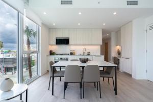 a kitchen and dining room with a table and chairs at Level Long Beach - East Village in Long Beach