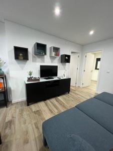 a bedroom with a bed and two monitors on the wall at Casa da Margarida in Vila Nova de Foz Coa +4 photos
