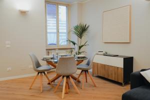 a living room with a dining room table and chairs at Exclusive Apartment in Piazza Italia in Perugia in Perugia