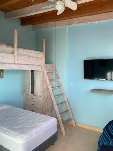a bedroom with two bunk beds and a flat screen tv at the best view in Valle de Bravo in Valle de Bravo