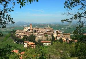 a village on top of a hill with houses at La Piazzetta in Bettona