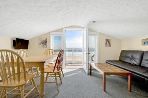 a living room with a table and chairs and a couch at Abellona Inn & Suites in Old Orchard Beach