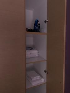 a closet with a door open with towels at Christi Apartments B in Kokkini Khanion
