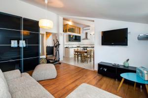 a living room with a couch and a tv at Apartments Vanda Rovinj in Rovinj