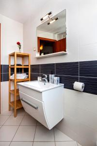 a bathroom with a sink and a mirror at Apartments Vanda Rovinj in Rovinj