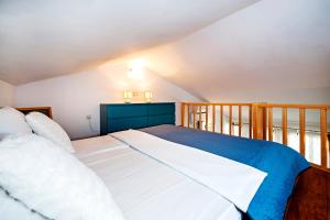a bedroom with a large bed and a balcony at Apartments Vanda Rovinj in Rovinj +53 photos