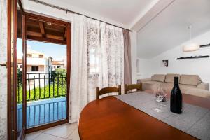 a living room with a table and a window at Apartments Vanda Rovinj in Rovinj