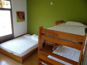 two bunk beds in a room with green walls at Andalucia in Villavicencio