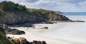 - Vistas a una playa con rocas y al océano en Gîte Atypique avec jacuzzi en Hillion