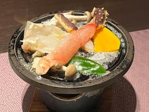 a drink with vegetables and other items on a table at Monbetsu Prince Hotel in Mombetsu