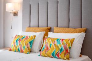 a bed with two pillows and a headboard at Vila Luna B&B in Lagos