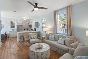 a living room with a couch and a table at Bungalows at Seagrove 135 - MerSea in Seagrove Beach