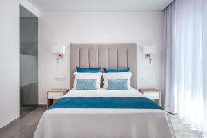 a bedroom with a large bed with blue and white pillows at Vila Luna B&B in Lagos +28 photos