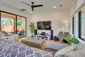 a living room with a bed and a tv at Chic Austin House with Spacious Backyard and Hammock in Austin