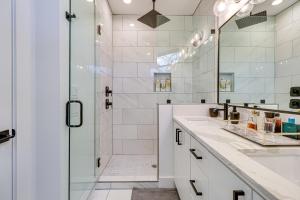 a white bathroom with a shower and a sink at Chic Austin House with Spacious Backyard and Hammock in Austin +28 photos