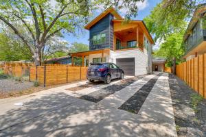 a car parked in front of a house at Chic Austin House with Spacious Backyard and Hammock in Austin