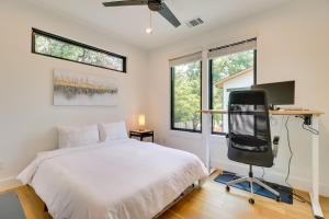 a bedroom with a bed and a desk and a tv at Chic Austin House with Spacious Backyard and Hammock in Austin