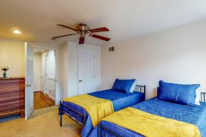 a bedroom with two beds and a ceiling fan at The Trailblazing Tribble House of Federal Hill in Baltimore