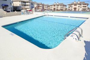 a swimming pool with blue water in a apartment at Pinehurst X-6 in Little River