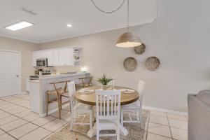 a kitchen and dining room with a table and chairs at Palm Tree Paradise in Padre Island