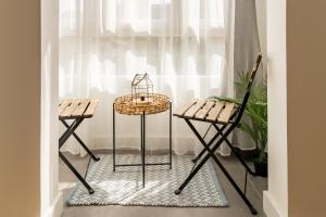 a table and two chairs in front of a window at Apartamento de diseño en el corazón de Santander in Santander