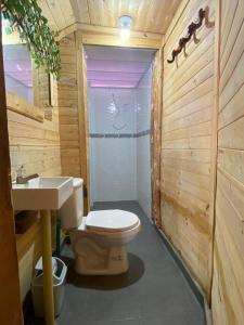 a bathroom with a toilet and a sink at Raw KokoMar PosadaNativa in Baru