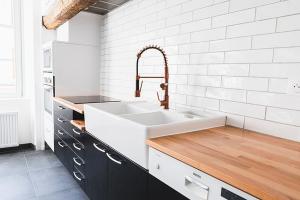 a kitchen with a sink and a white wall at Coeur de Ville à partager in Montbéliard