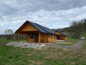 a log cabin in a field with at U dziewczyn w Terce in Terka