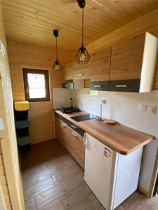 a kitchen with wooden walls and a wooden counter top at U dziewczyn w Terce in Terka +47 photos