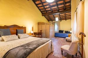 a bedroom with a large bed and a living room at Mas Rubió in Joanetes