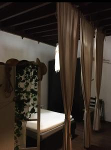 a bedroom with a bunk bed with curtains at Piso Puerto in El Puerto de Santa María