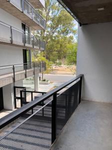 a stairway leading to a building with a balcony at Monoambiente parque p in Villa María +1 photo