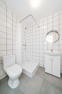 a white bathroom with a toilet and a sink at Kalniečių st 126A Kaunas Students Home LT in Kaunas