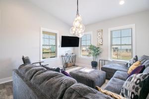 a living room with two couches and a tv at Steps Away from Cruisin' the Coast , Gulfport 2BR, Game Room, and Free Parking in Gulfport