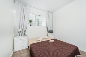 a white bedroom with a bed and a window at Kalniečių st 126A Kaunas Students Home LT in Kaunas