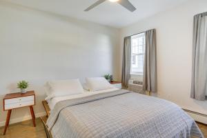 a white bedroom with a bed and a window at Asbury Park Condo Less Than Half-Mi to Beach and Boardwalk! in Asbury Park