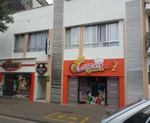 a store with a sign on the side of a building at Hotel Cafetto in Pereira
