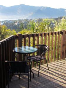 una mesa y 2 sillas en una terraza con vistas en Bayview Studio en Diamond Harbour